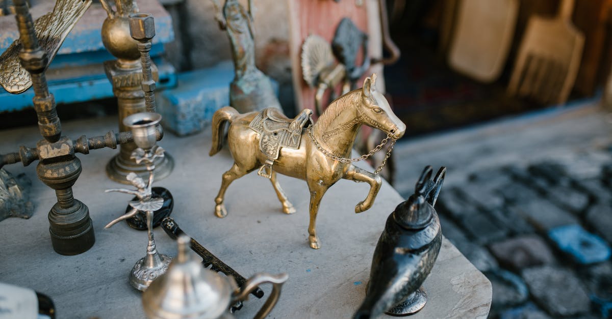 How do I collect loot stored in my town hall? - High angle many copper and metal oriental souvenirs arranged on stall in local street market