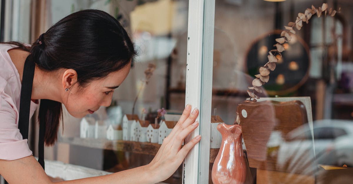 How do I collect loot stored in my town hall? - Side view of young ethnic female leaning forward while touching glass wall of store in town How do I collect loot stored in my town hall? - Side view of young ethnic female leaning forward while touching glass wall of store in town