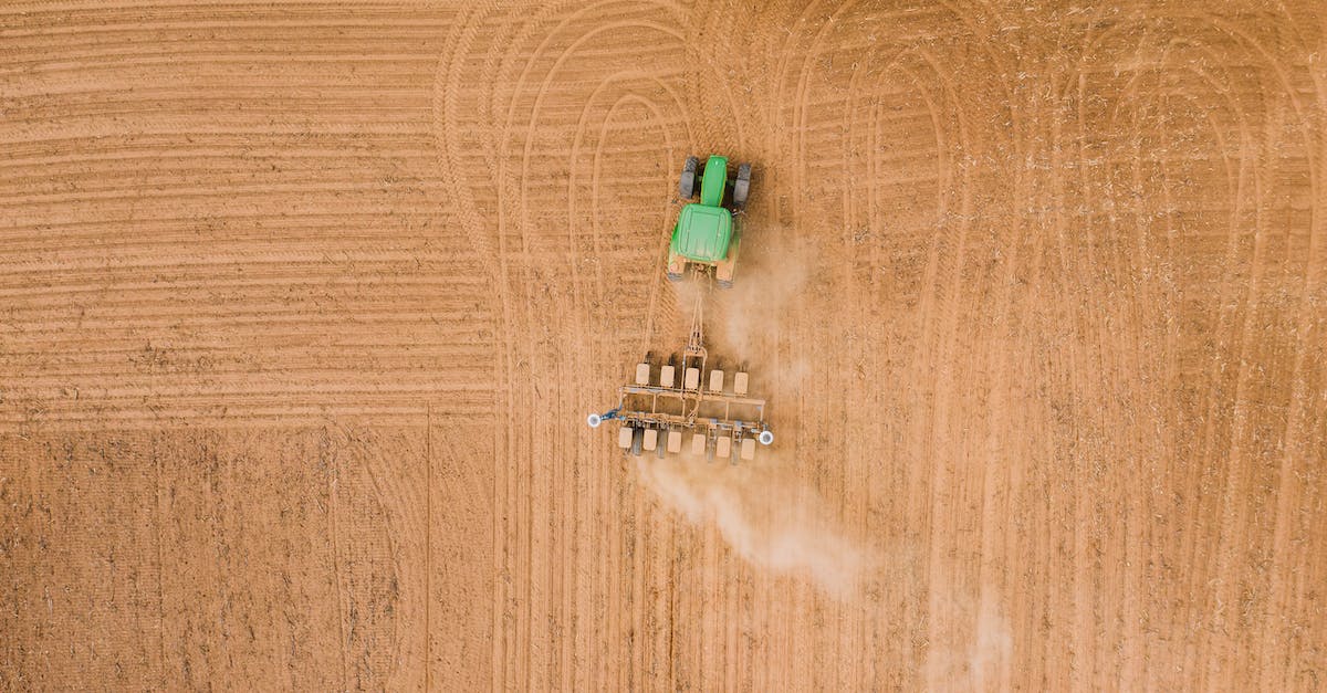 How do I combine my Equipment? - Field engine ploughing plantation in daylight