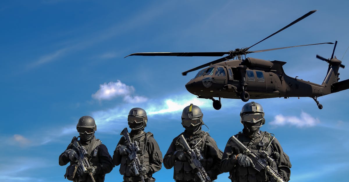 How do I combine weapons with special characteristics? - Four Soldiers Carrying Rifles Near Helicopter Under Blue Sky