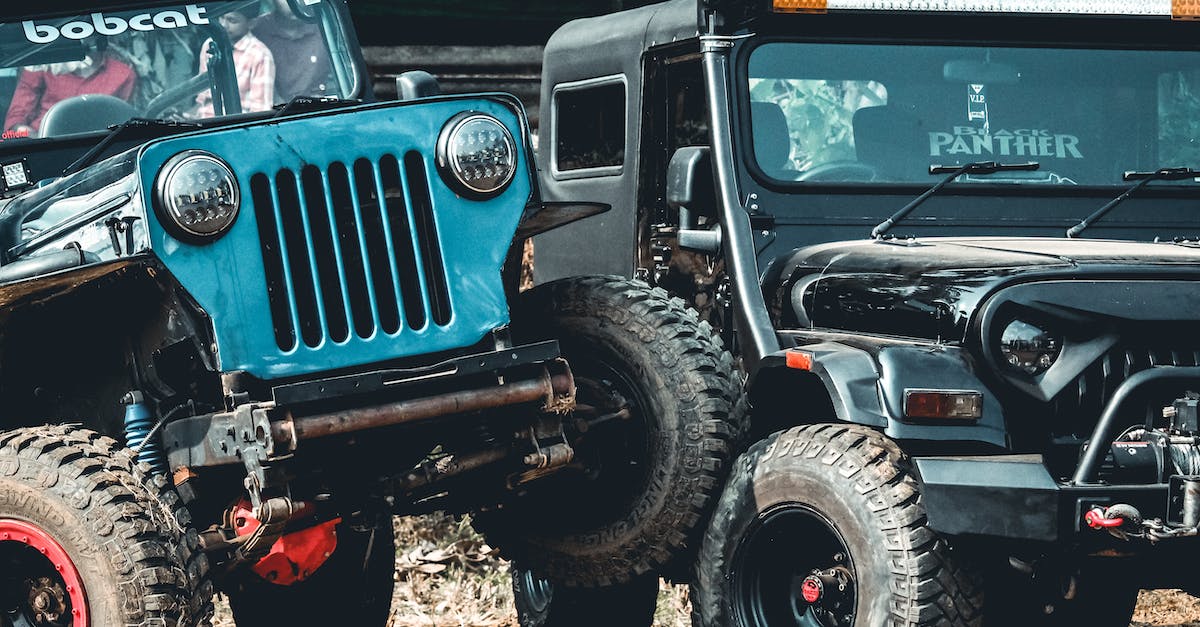 How do I complete the "Get hit by a car" challenge in Goat Simulator? - SUV cars riding along dusty road during competition in countryside