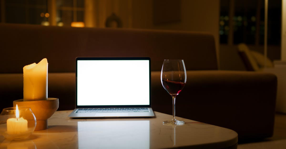How do I configure Diablo 2 in Wine to -skiptobnet and -w? - A Laptop beside a Glass of Wine and Lighted Candles