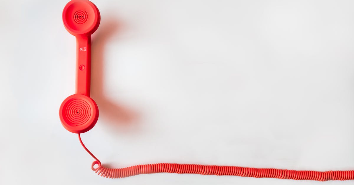How do I contact Rockstar customer support? - Red Corded Telephone on White Suraface