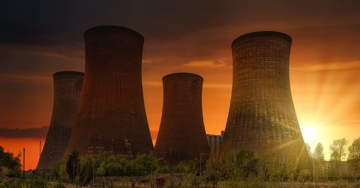 How do I cool my reactor hull? - Exterior of huge cooling towers located in contemporary atomic power plant against bright setting sun under dramatic dark sky