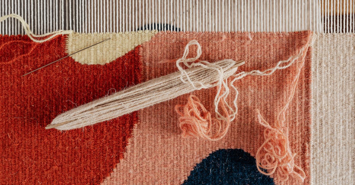 How do I create a doughnut shape in WorldEdit? - From above of shuttle and needle placed on part of handmade carpet with circle pattern on loom frame during weaving process How do I create a doughnut shape in WorldEdit? - From above of shuttle and needle placed on part of handmade carpet with circle pattern on loom frame during weaving process