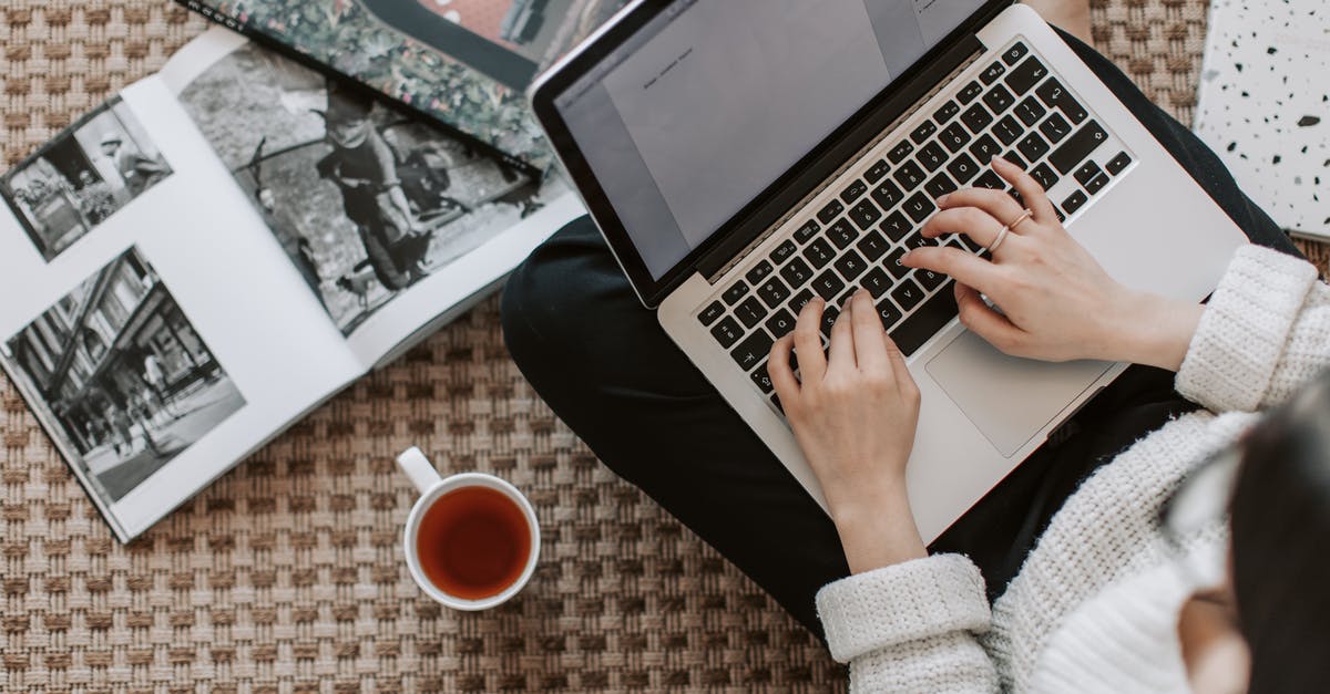 How do I create a repeating charge using redstone/repeaters? - Crop young businesswoman using laptop while drinking tea at home