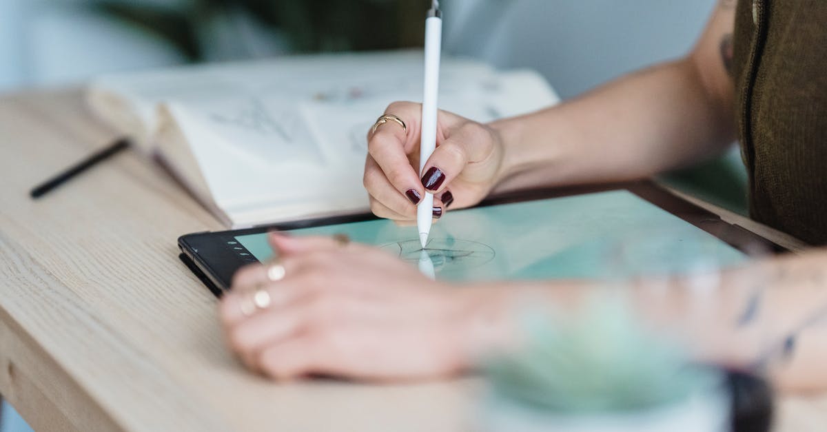 How do I create a repeating charge using redstone/repeaters? - Crop unrecognizable female designer using tablet and stylus for drawing sketches on wooden table