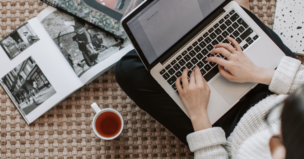 How do I create an Ender Portal using commands? - Crop young businesswoman using laptop while drinking tea at home