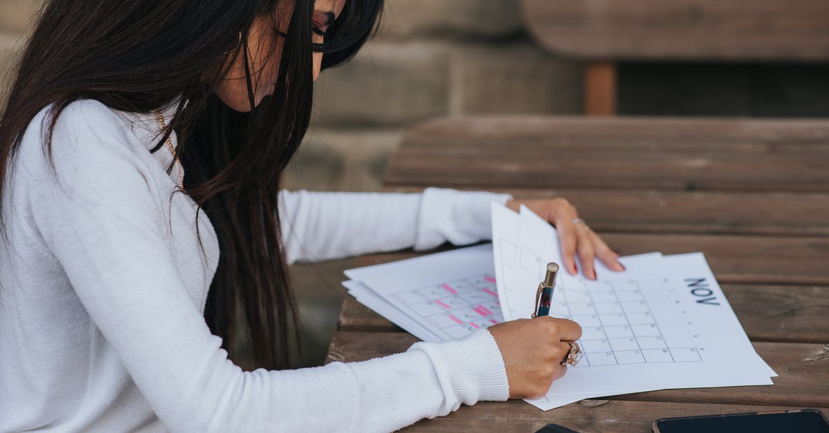 How do I delete highlighted comments? - Crop ethnic office employee making schedule at table How do I delete highlighted comments? - Crop ethnic office employee making schedule at table
