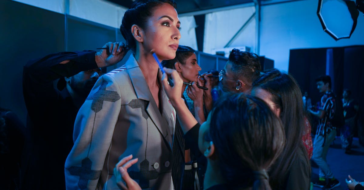 How do I determine the value of a knife? - Unrecognizable visagiste applying makeup on face of actress