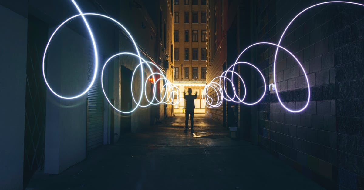 How do I disable the dynamic contrast (aka auto exposure)? - Long exposure full body person silhouette making circles with bright flashlight while standing on narrow dark city street between tall urban buildings How do I disable the dynamic contrast (aka auto exposure)? - Long exposure full body person silhouette making circles with bright flashlight while standing on narrow dark city street between tall urban buildings
