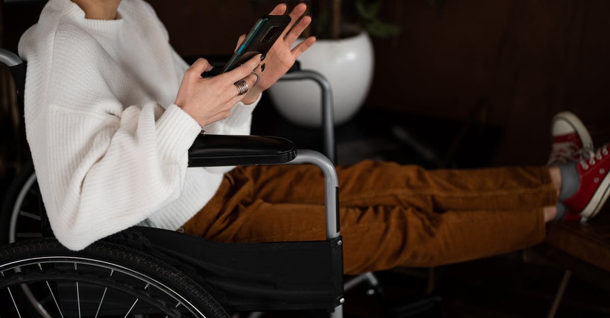 How do I disable Ubisoft Connect popups? - Side view of crop unrecognizable female millennial with disability sitting in wheelchair and browsing mobile phone How do I disable Ubisoft Connect popups? - Side view of crop unrecognizable female millennial with disability sitting in wheelchair and browsing mobile phone
