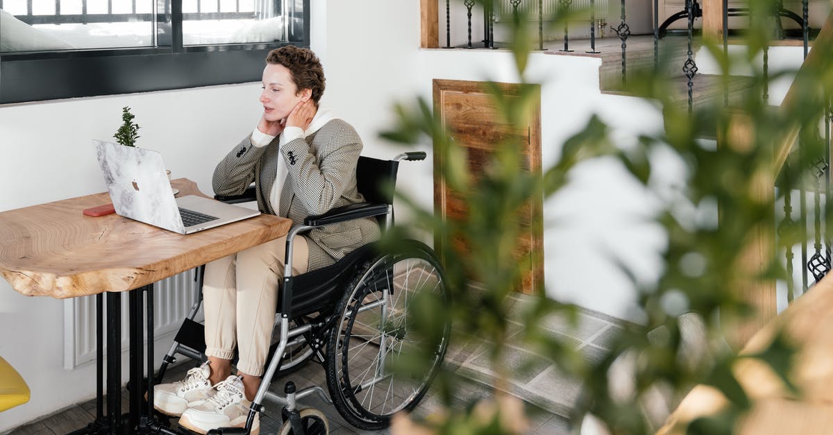 How do I disable Ubisoft Connect popups? - Focused disabled woman working at table with laptop in cafe How do I disable Ubisoft Connect popups? - Focused disabled woman working at table with laptop in cafe