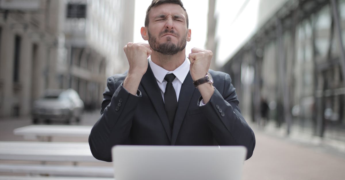 How do I earn credits? - Man in Black Suit Sitting on Chair Beside Buildings