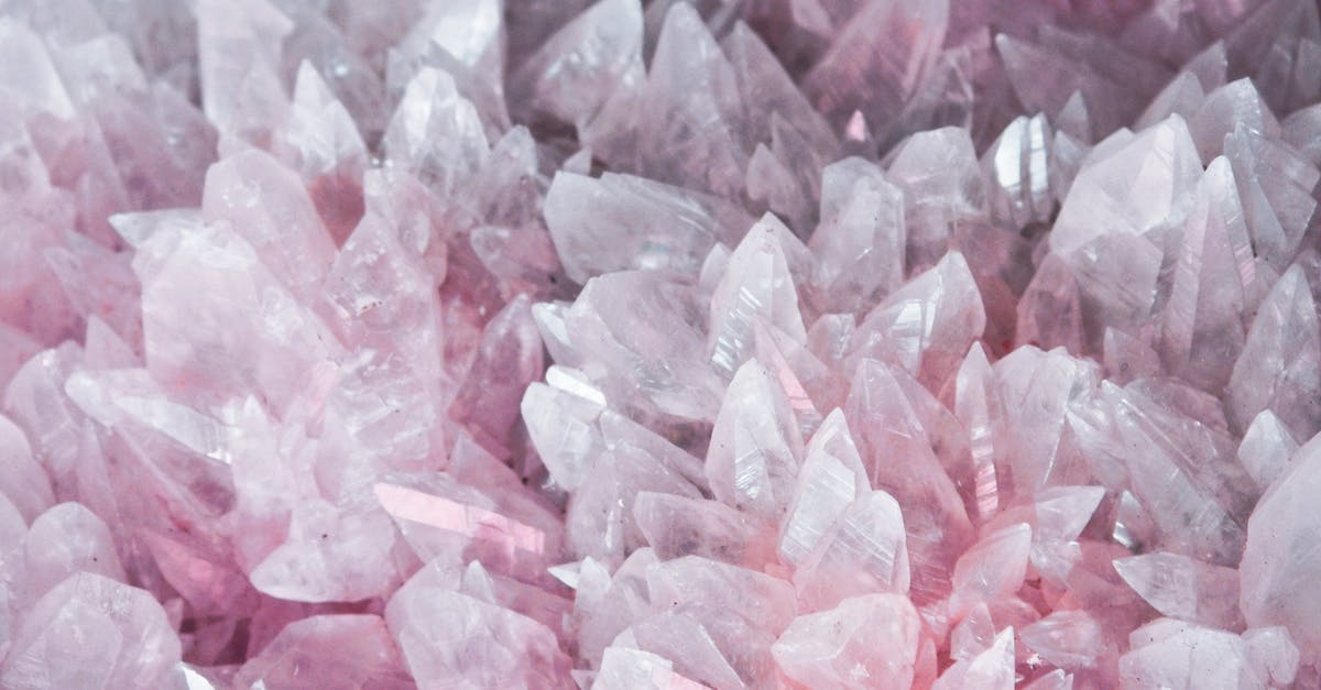 How do I earn gems in Clash of Clans? - Pink and White Stones