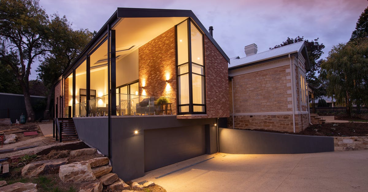How do I enable Silent Mode? - Contemporary building facade with glowing lamps near walkway at sunset How do I enable Silent Mode? - Contemporary building facade with glowing lamps near walkway at sunset