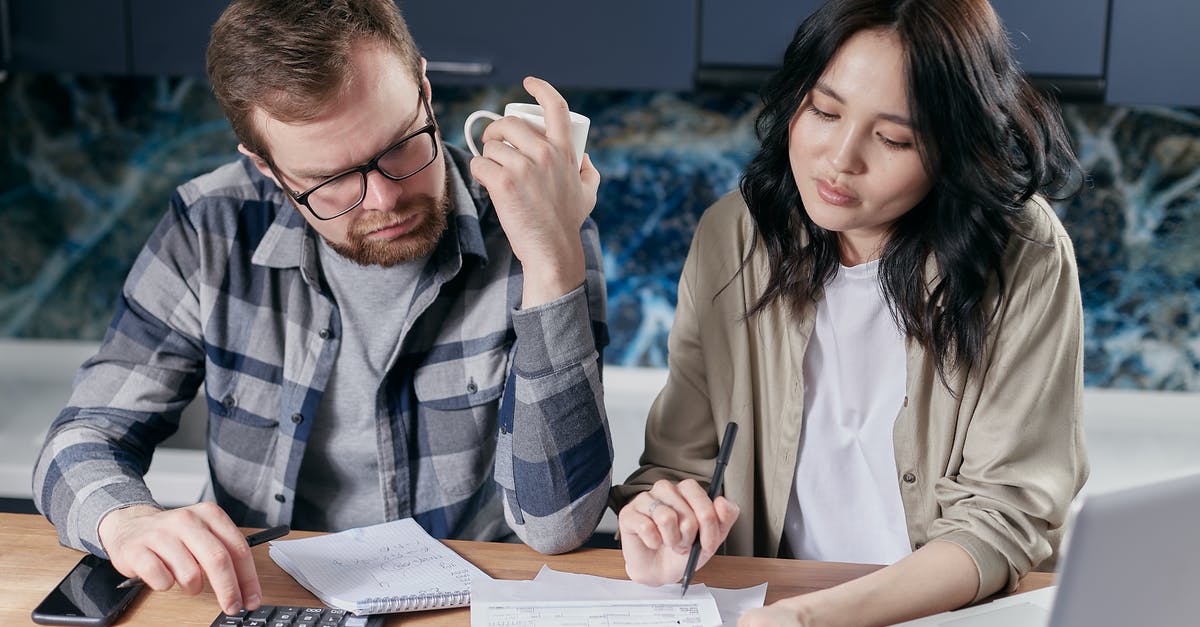 How do I estimate the requirements for my laundry? - Couple Looking at their Bills