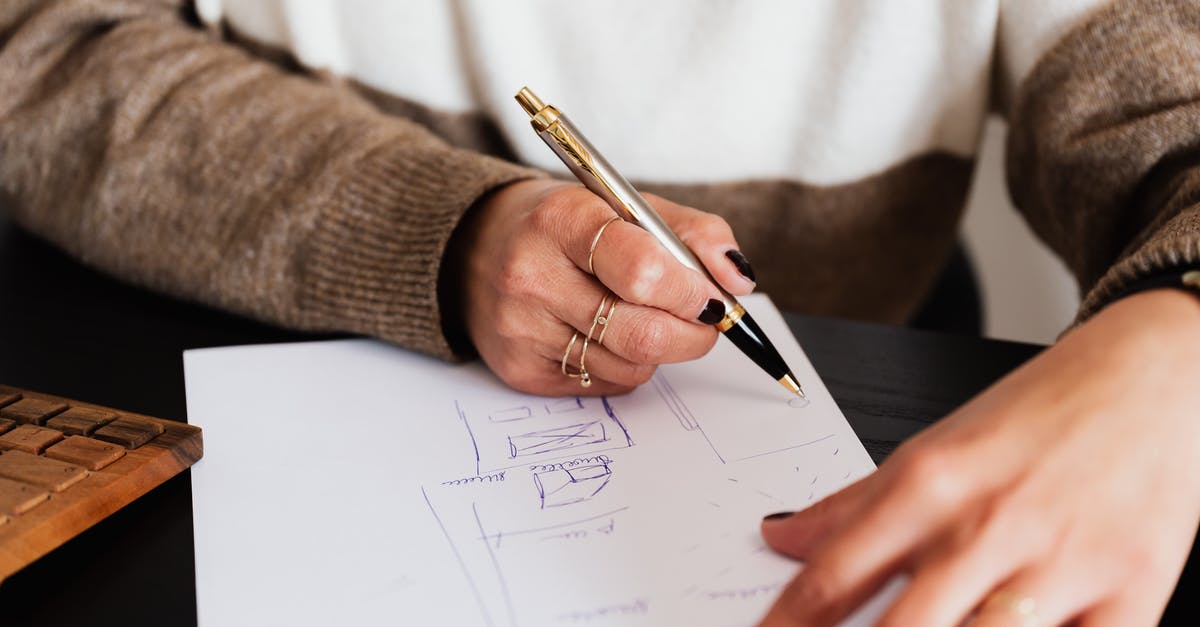 How do I estimate the requirements for my laundry? - Crop anonymous elegant lady drawing draft plan of room with pen sitting at computer desk
