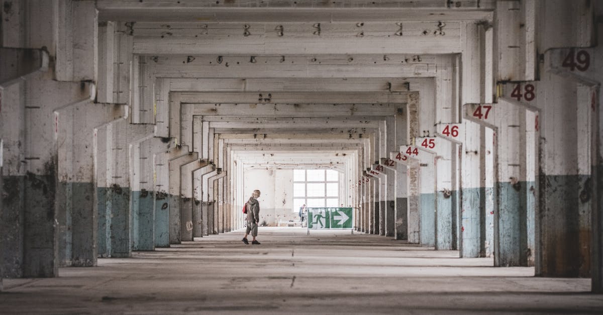 How do I exit the Bastion of Faith? - Woman in White Shirt Walking on Hallway
