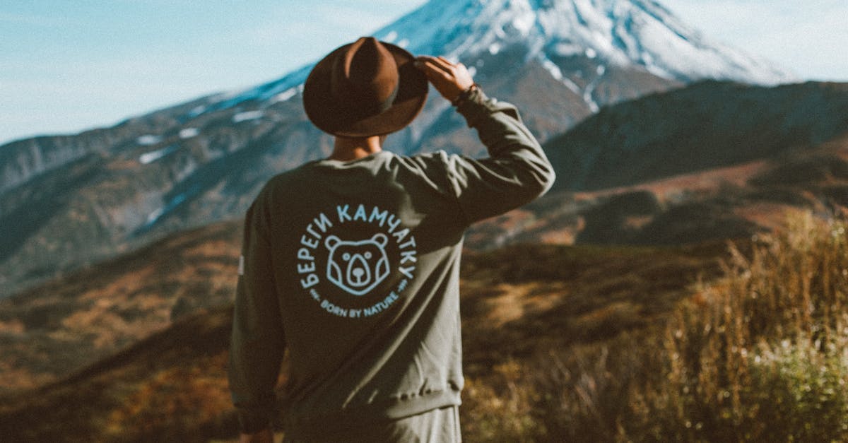 How do I explore unknown land (terra incognita)? - Lonely man in hat admiring picturesque view