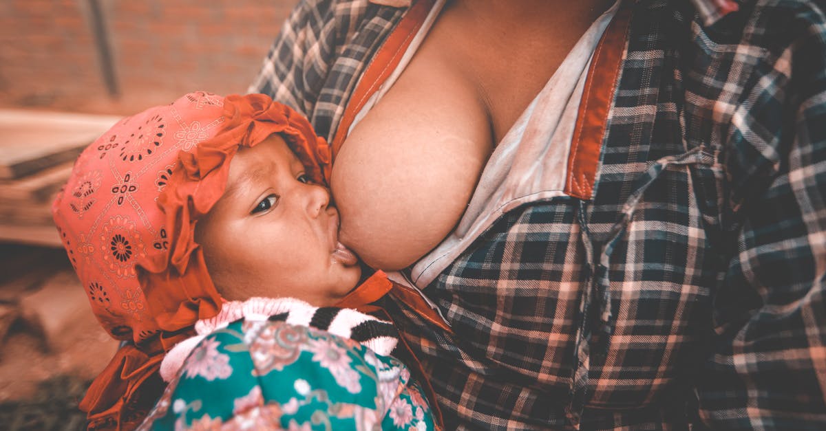 How do I feed the locals? - Ethnic young mother breastfeeding baby in village How do I feed the locals? - Ethnic young mother breastfeeding baby in village