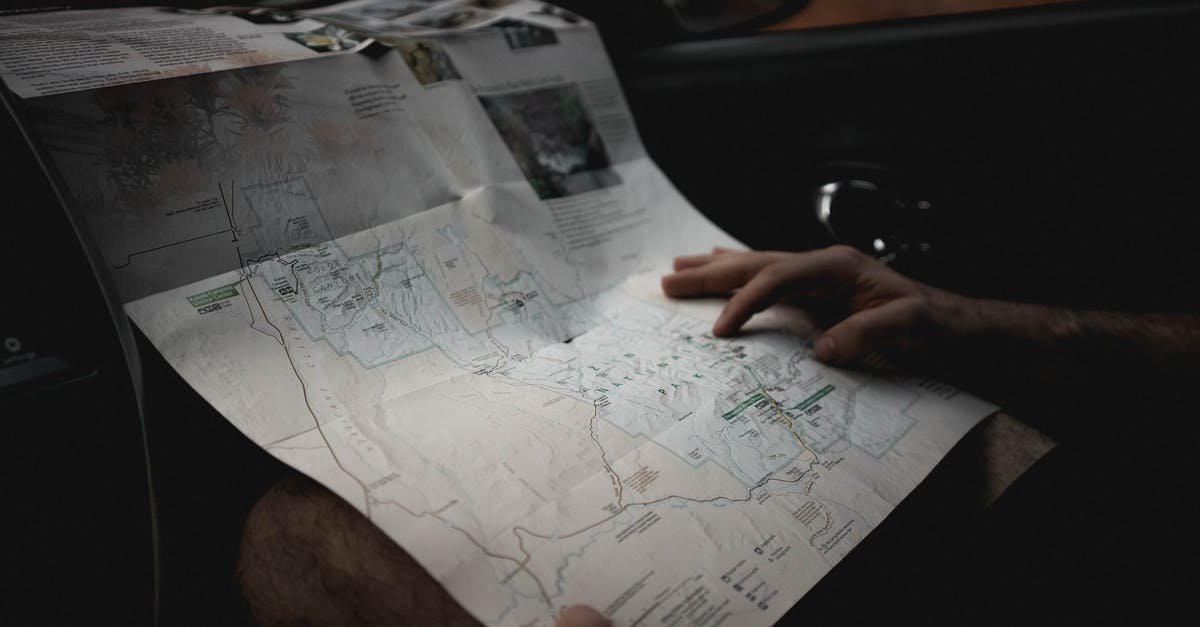 How do I find the worm-riding manual pages? - Crop man with map in automobile
