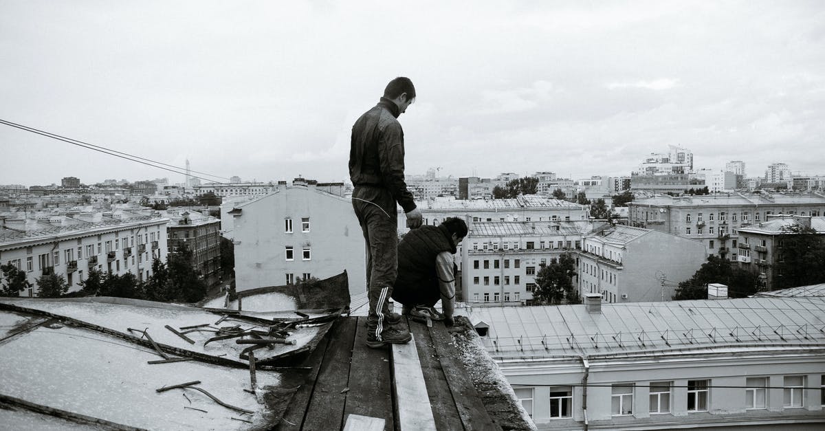 How do I fix this black border problem in games - Black and white full body of anonymous man changing roof on broken building located in residential area of city