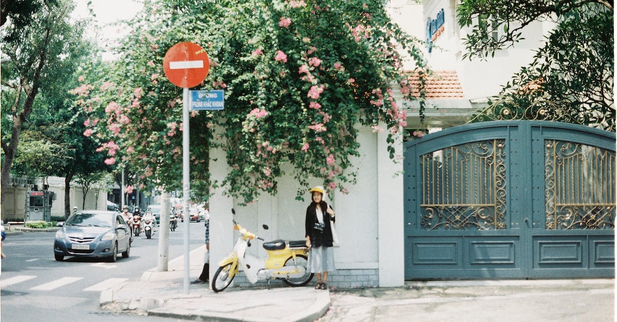 How do I get a car or motorcycle permanently? - Man in Black Jacket Riding Yellow Motor Scooter Near Green Tree