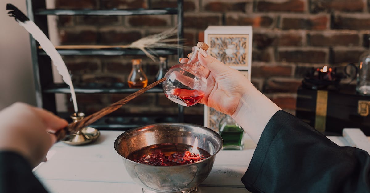 How do I get a flight potion flask? - A Person Holding Wooden Stick and Clear Glass Bottle with Red Liquid