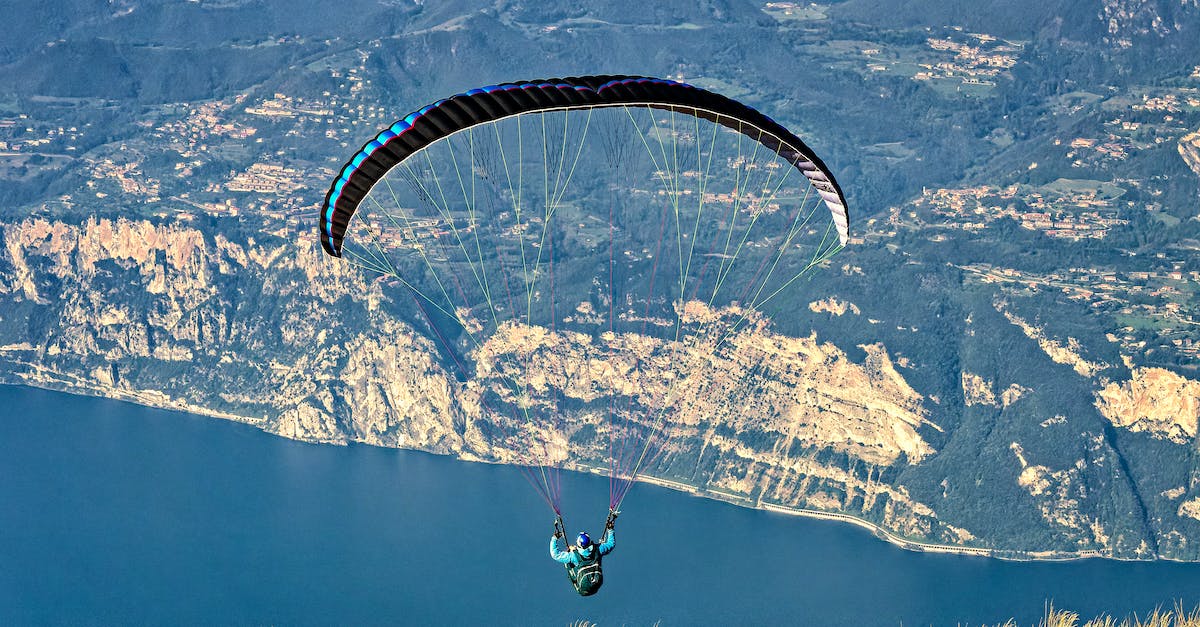 How do I get a flight potion flask? - Person in Green Jacket Riding on Parachute over the Mountain