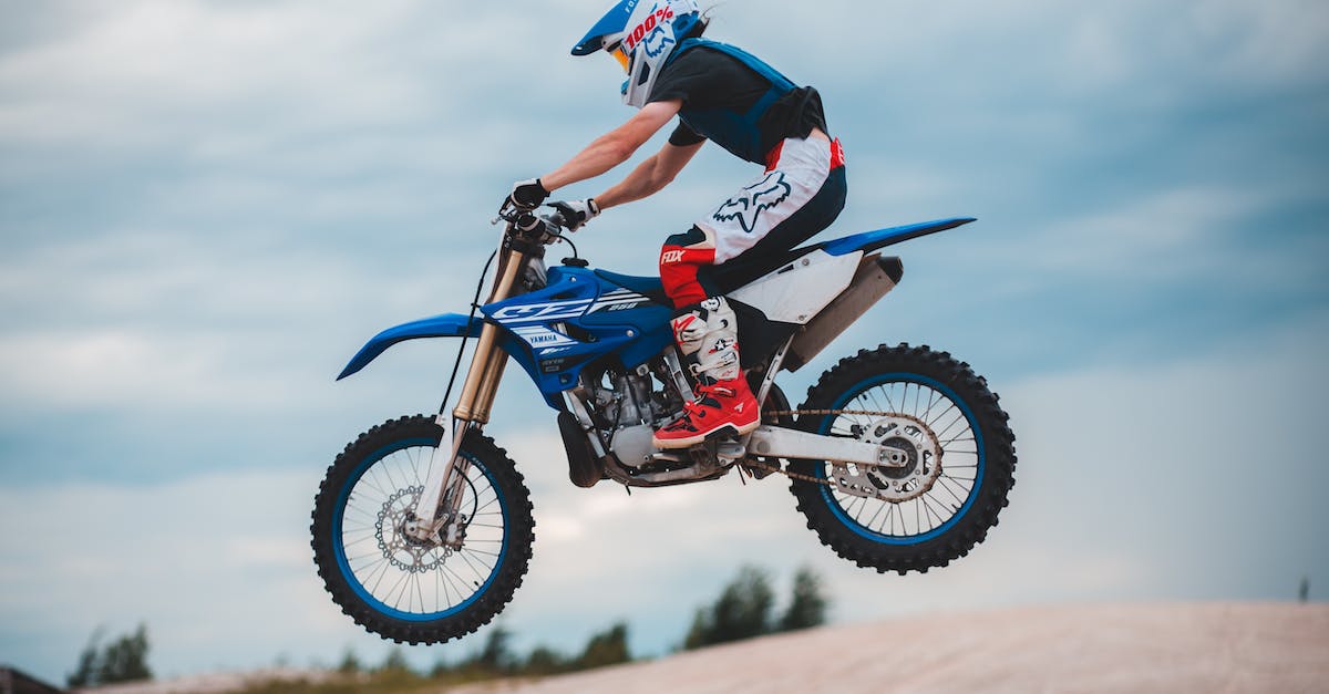 How do I get a lot of Stunt Driver points? - Unrecognizable man riding enduro motorbike in air