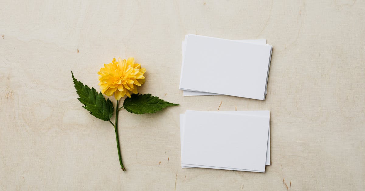How do I get a yellow card back? - Blank mockup business cards and yellow flower on desk