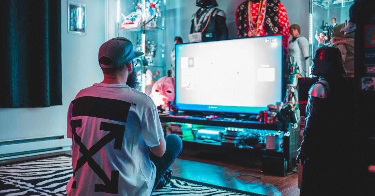 How do I get back a lost PG3D account using Game Center on IOS? - Unrecognizable man using controller at home