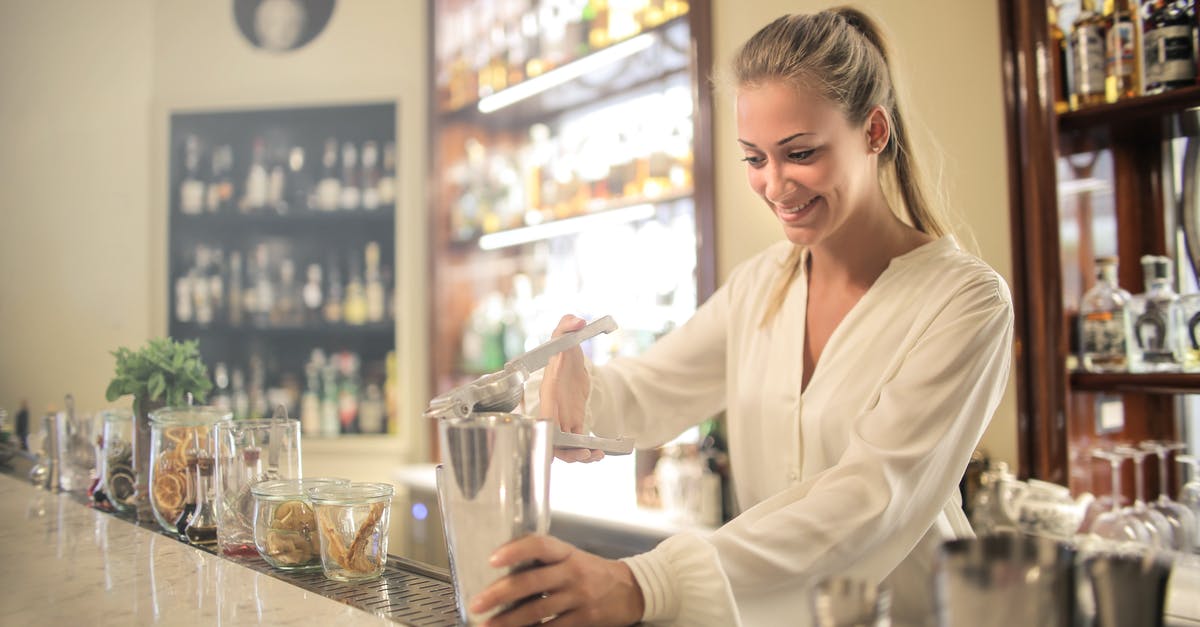 How do I get bartenders to make drinks in Dragon Quest Builders 2? - Smiling blonde in white blouse squeezing fresh juice into stainless shaker while preparing cocktail in bar
