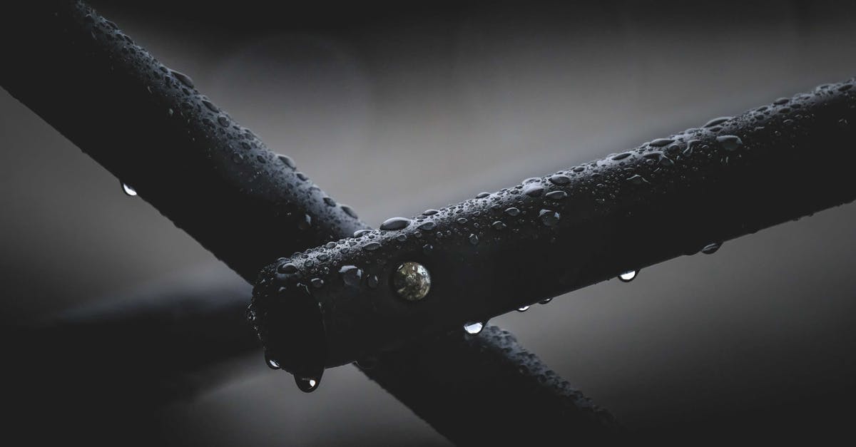 How do I get Dispel Barrier Level 3 in Avernum 2: Crystal Souls? - Closeup of part of wet steel fence covered with clear pure transparent raindrops