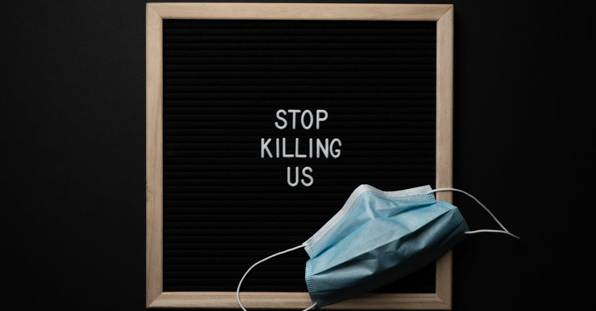 How do I get Gleda the Goat to stop trying to kill me? - Top view of composition of blackboard with written phrase STOP KILLING US under mask against black background