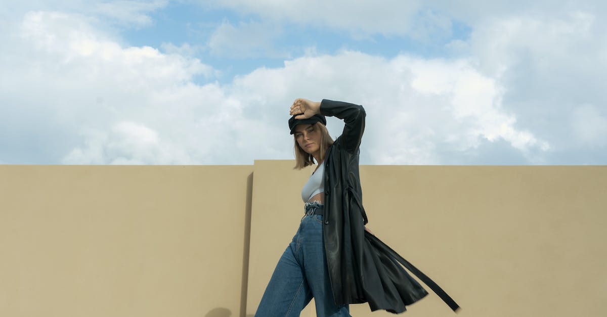 How do I get leather in Agrarian Skies? - Woman in Black Leather Trench Coat Standing Near the Yellow Wall