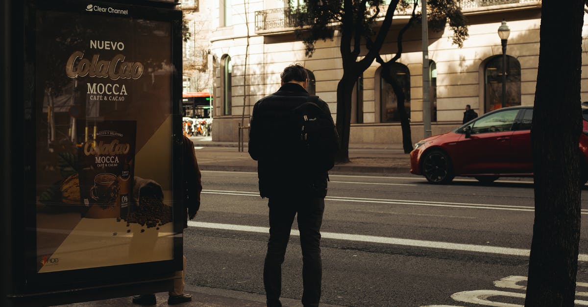 How do I get my car back? (GTA V offline) - Back view of man reflecting in mirror while driving along street in city on urban background in soft daylight