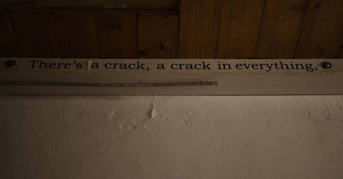 How do I get out of the spiked ceiling room? - From below of phrase written on paper and nailed on white shabby wall near wooden ceiling in room in neglected house How do I get out of the spiked ceiling room? - From below of phrase written on paper and nailed on white shabby wall near wooden ceiling in room in neglected house