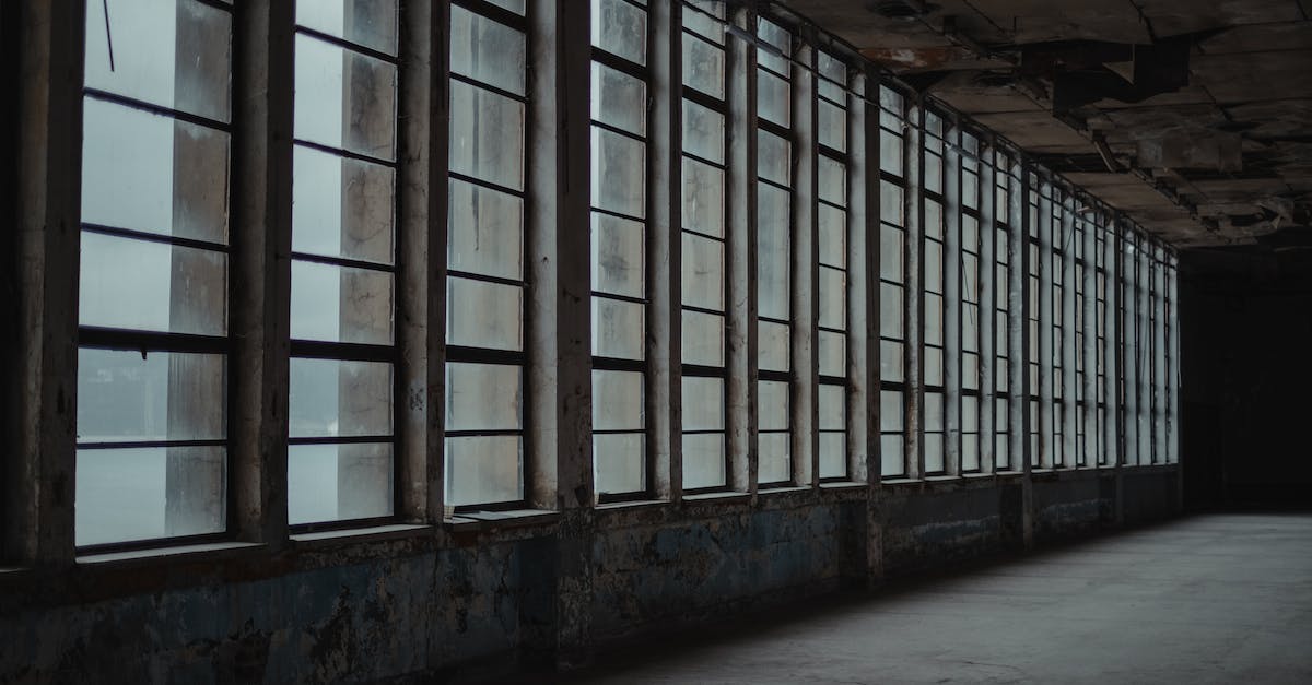 How do I get out of the spiked ceiling room? - Interior of desolated room with shabby concrete walls and raw of big windows How do I get out of the spiked ceiling room? - Interior of desolated room with shabby concrete walls and raw of big windows