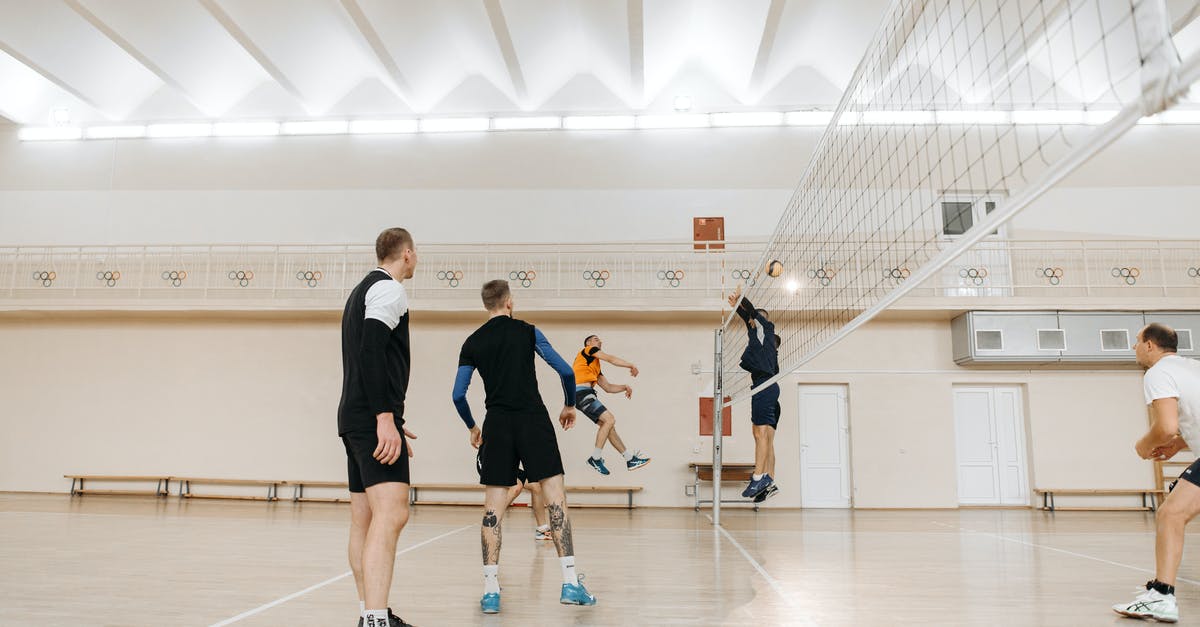 How do I get past players blocking doorways? - Men Playing Volley Inside a Covered Court