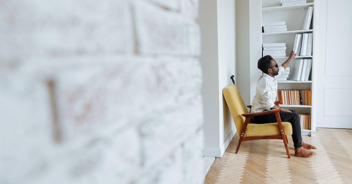 How do I get rid of the Blind Bruiser? - A Man Sitting on a Chair and Getting a Book on the Shelves