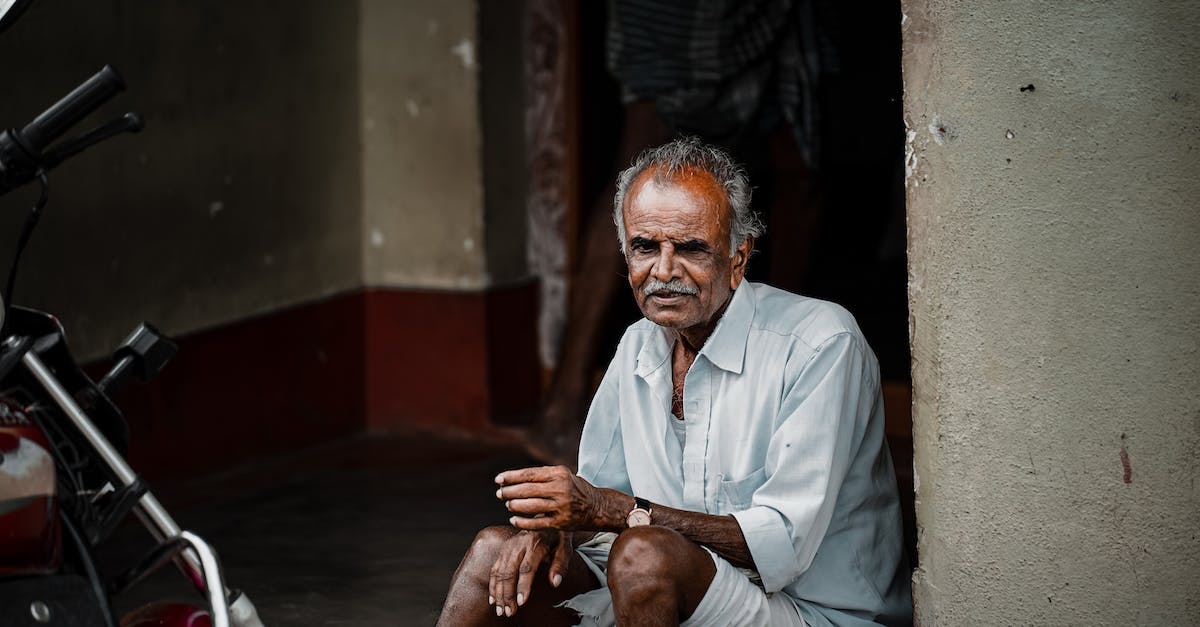 How do I get rid of the Blind Bruiser? - Man in White Button Up Shirt Sitting on Red Chair