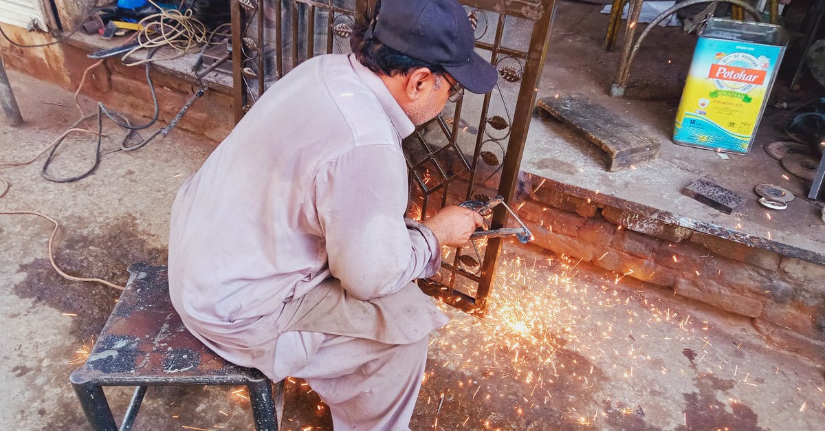 How do I get the NOT, NAND, NOR and XNOR logic gates to work? - Man Sitting on a Stool While Repairing a Gate