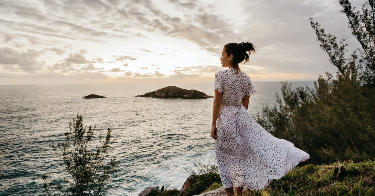 How do I get the rest of my catalog items back? - Back view of calm young female traveler in elegant summer dress admiring seascape from grassy cliff against cloudy sunset sky in Arraial do Cabo How do I get the rest of my catalog items back? - Back view of calm young female traveler in elegant summer dress admiring seascape from grassy cliff against cloudy sunset sky in Arraial do Cabo