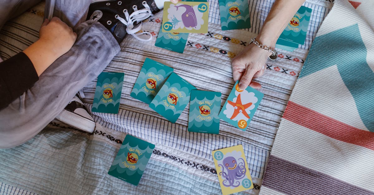 How do I get the third daily card from the Steam Monster game? - Top view of crop anonymous kid with mother playing card game with colorful marine pictures on bed during weekend at home