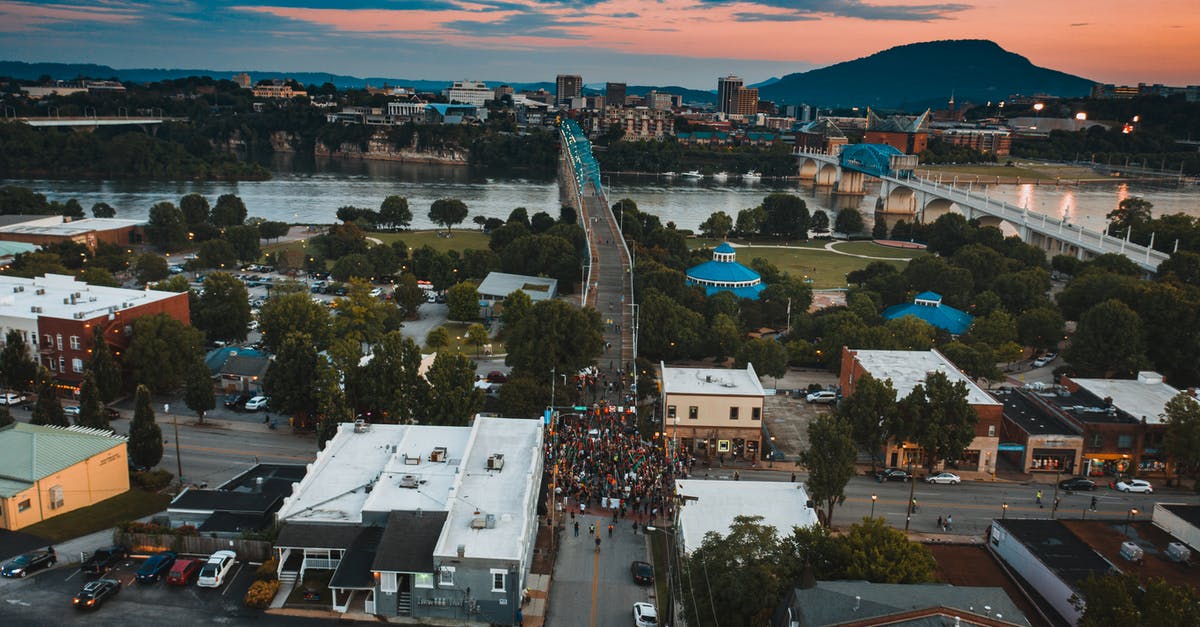 How do I get to the two puzzle pieces right at the end of Cloud Bridge? - Unrecognizable protesters on city road between houses during manifestation