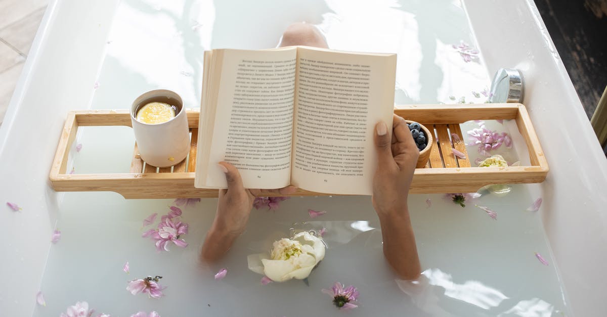 How do I get water from a well into my waterskin? - Woman reading book while resting in bathtub