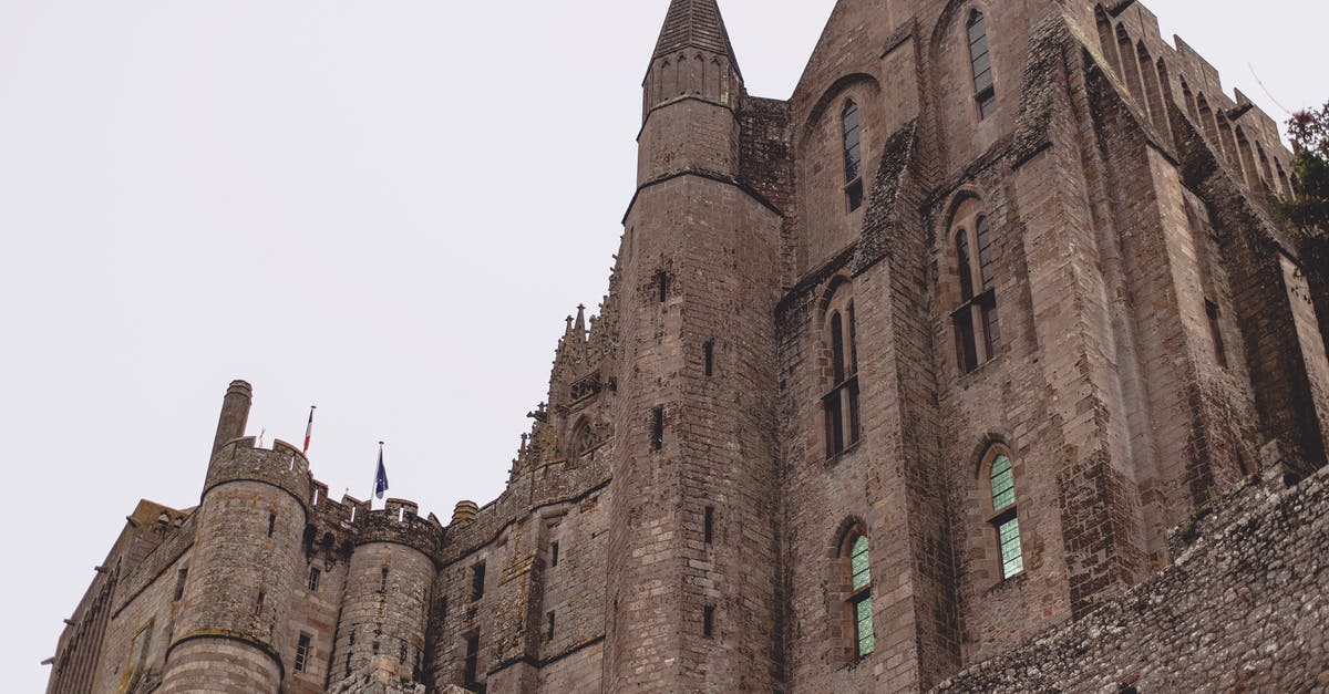 How do I go to The Fort from Cottonwood Cove if I'm vilified by the Legion? - Brick Gothic abbey castle against gray sky