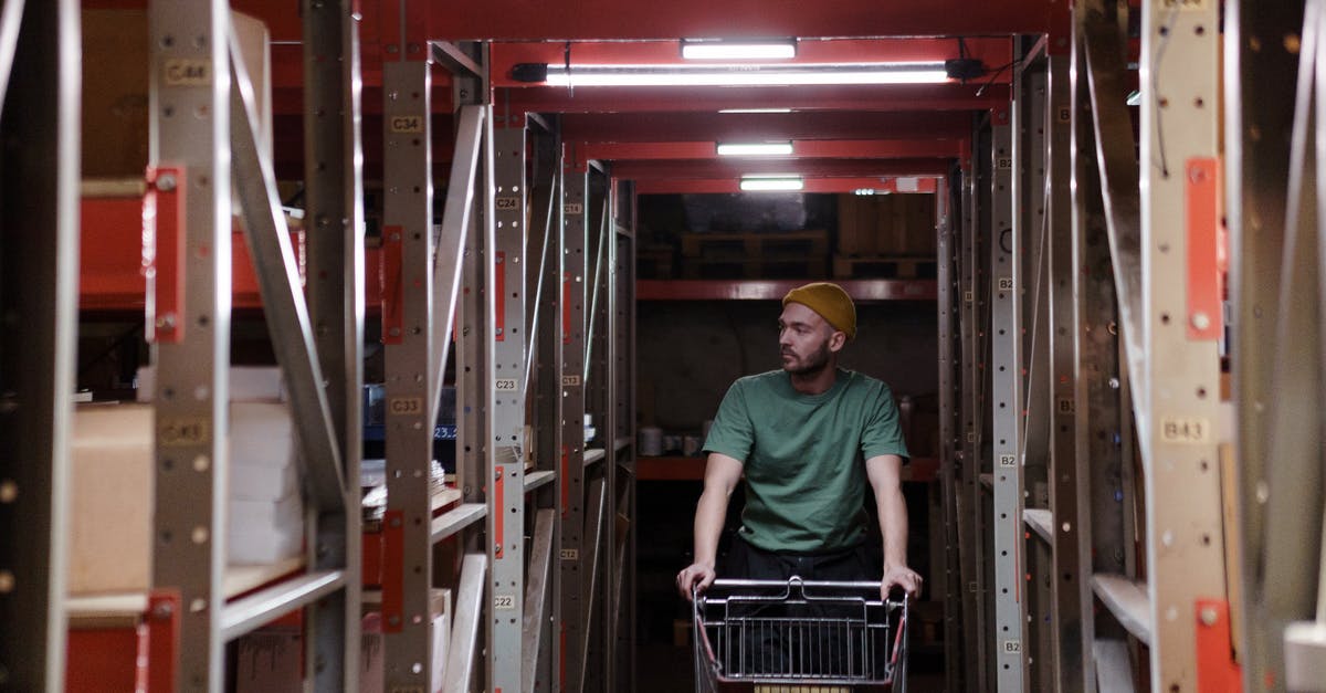 How do I increase my storage capacity? - Man in Green Polo Shirt and Blue Denim Jeans Sitting on Shopping Cart